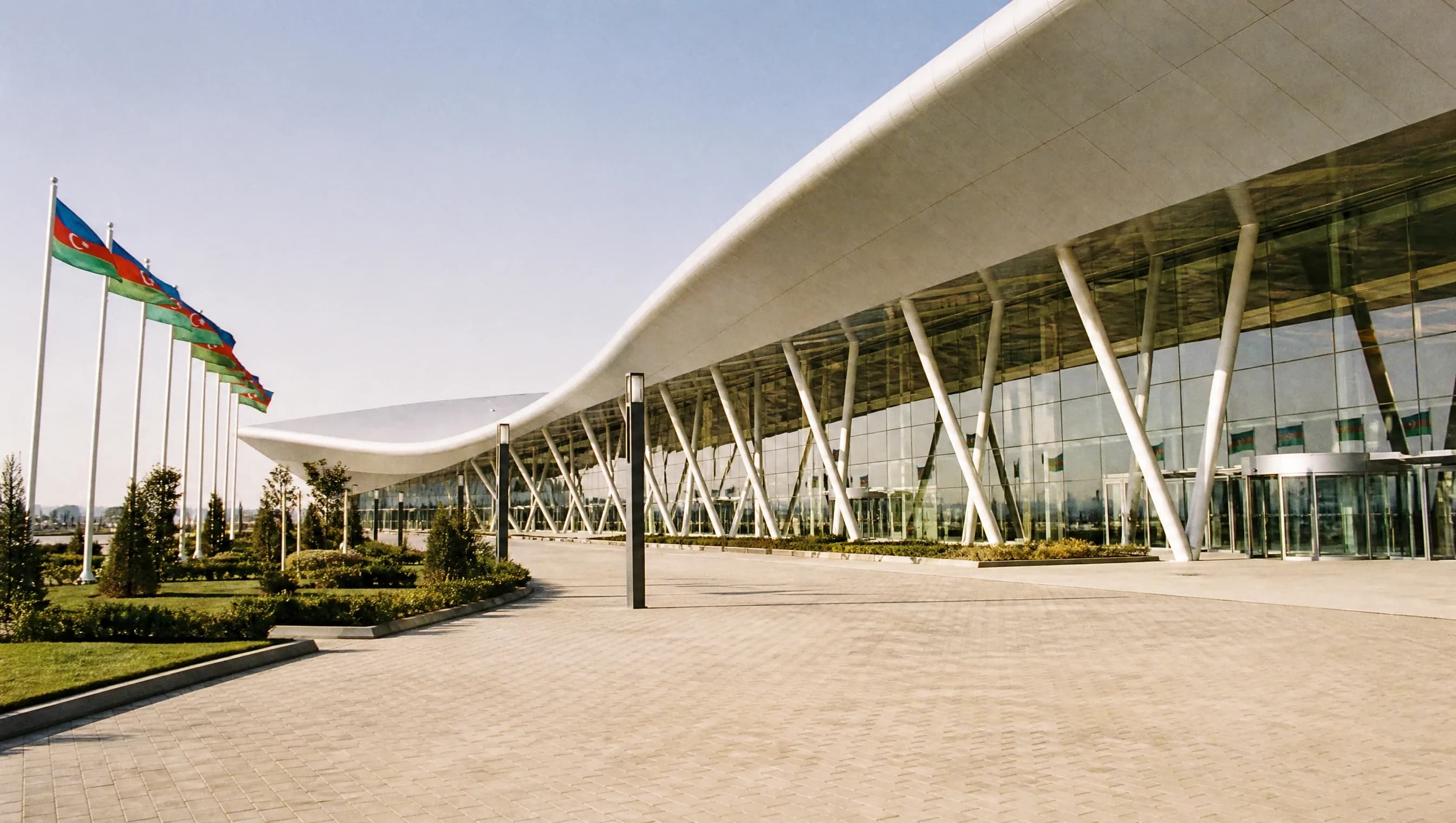 The glass facade and landscaped entrance of Baku Expo Center