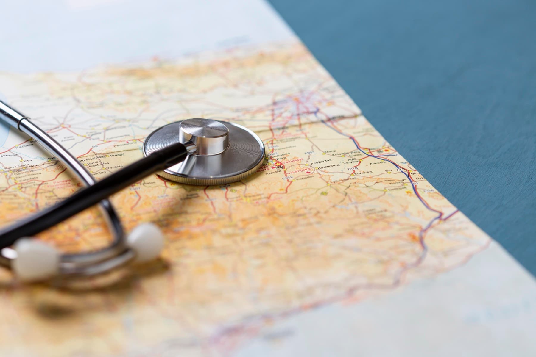 A stethoscope resting on a travel map