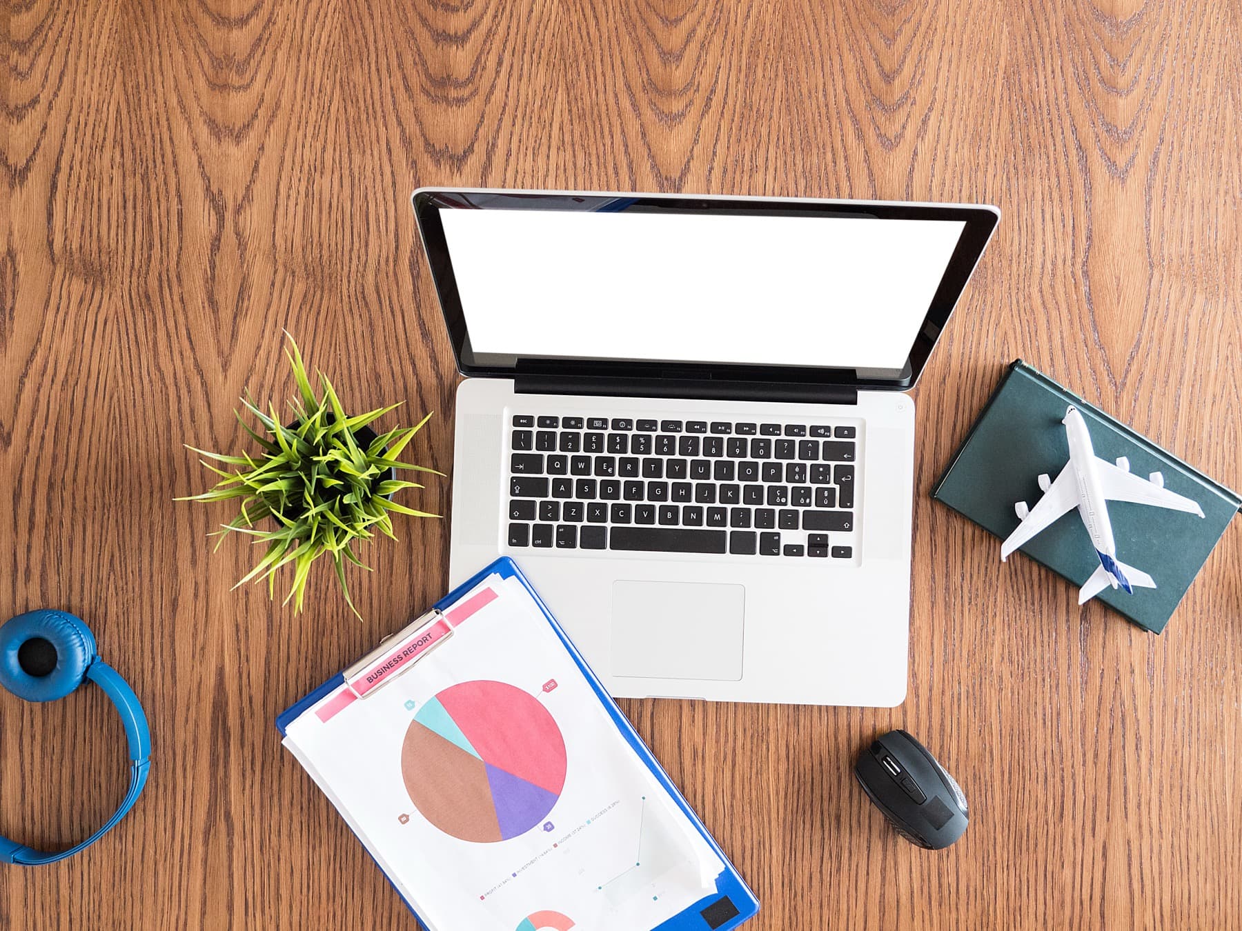 Business travel plans arranged beside a laptop
